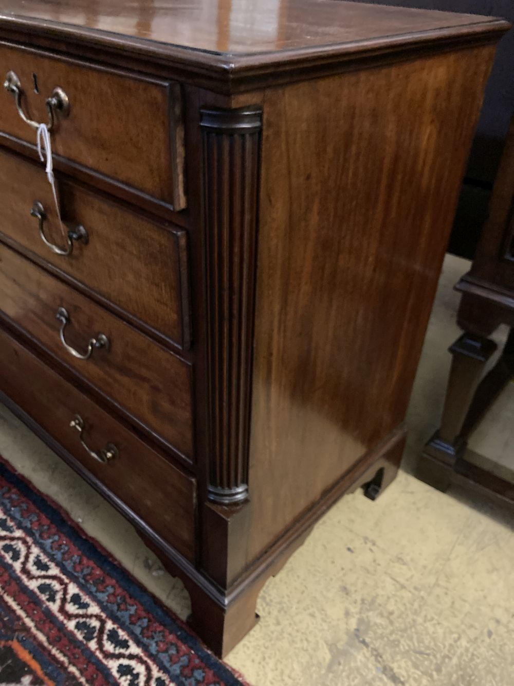 A George III satinwood strung mahogany chest with fluted column canted angles, width 104cm, depth 50cm, height 84cm